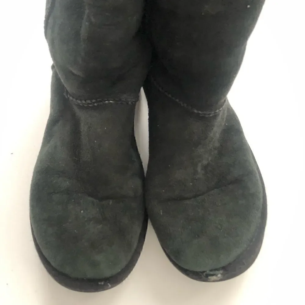 Ugg’s classic tall boots in black shearling lined
